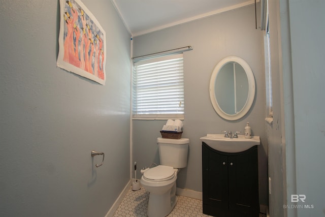 bathroom featuring toilet, tile patterned floors, baseboards, and vanity