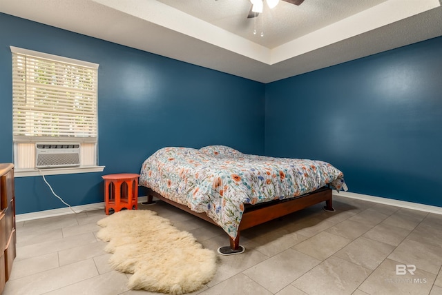 tiled bedroom with cooling unit, a textured ceiling, and ceiling fan