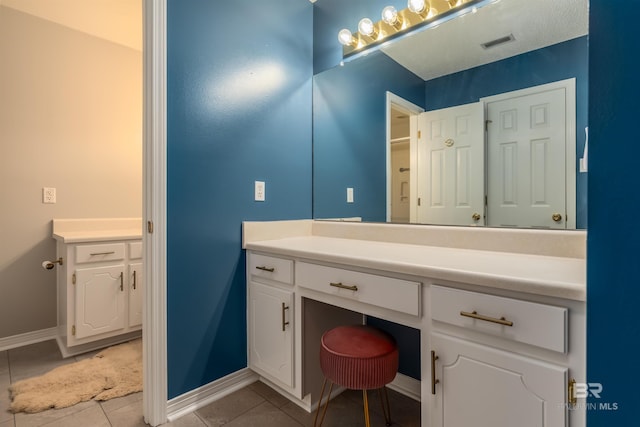 bathroom with vanity and tile patterned flooring