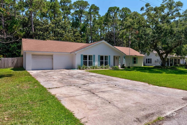 single story home featuring a garage and a front yard