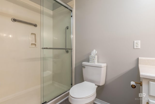 bathroom featuring walk in shower, vanity, and toilet