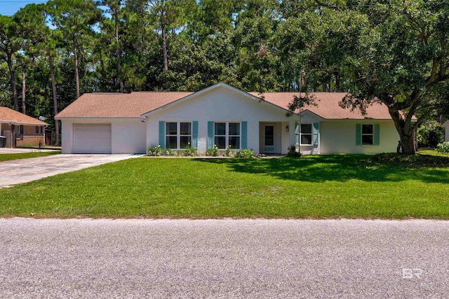 ranch-style house featuring a garage and a front yard