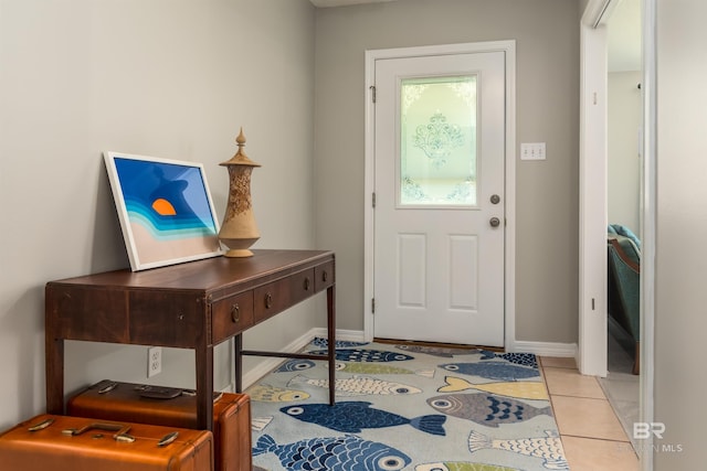 doorway to outside featuring light tile patterned flooring