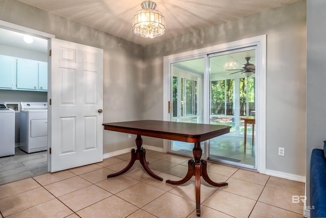 dining area with light tile patterned floors, ceiling fan with notable chandelier, and independent washer and dryer