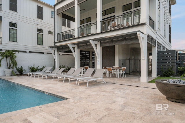 back of property with a balcony and a patio area