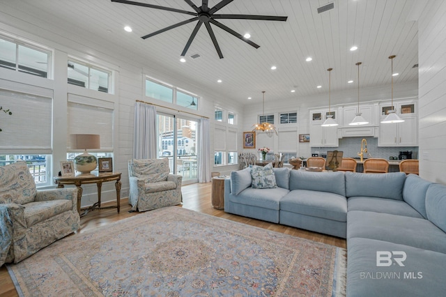 living room with wooden ceiling, plenty of natural light, and wood finished floors