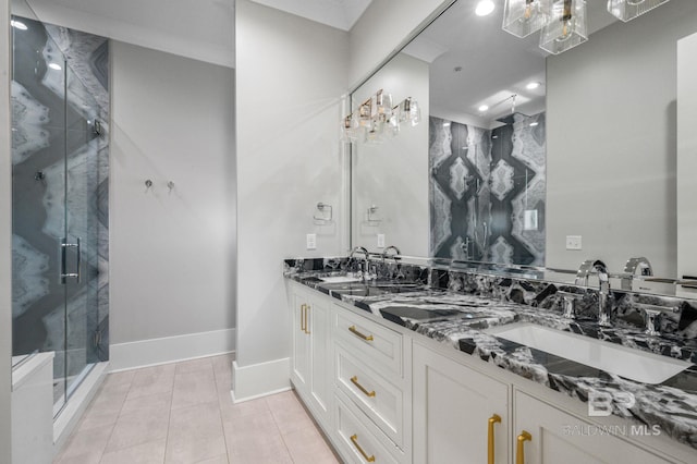 bathroom with double vanity, a sink, a marble finish shower, and tile patterned floors