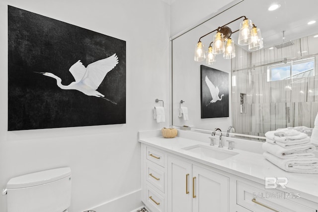 bathroom featuring toilet, recessed lighting, vanity, baseboards, and a stall shower