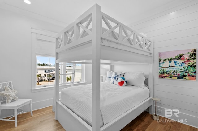 bedroom featuring wood finished floors and baseboards