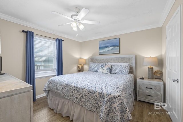 bedroom featuring ornamental molding, baseboards, ceiling fan, and wood finished floors