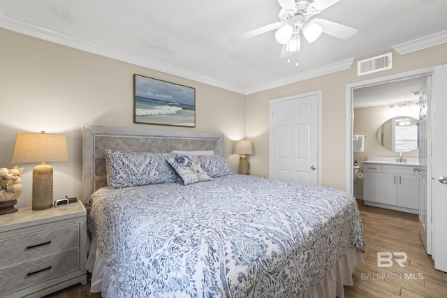 bedroom featuring light wood-style flooring, ensuite bath, ornamental molding, and visible vents
