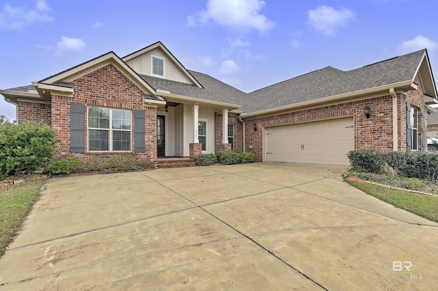 view of front of property with concrete driveway, brick siding, an attached garage, and roof with shingles