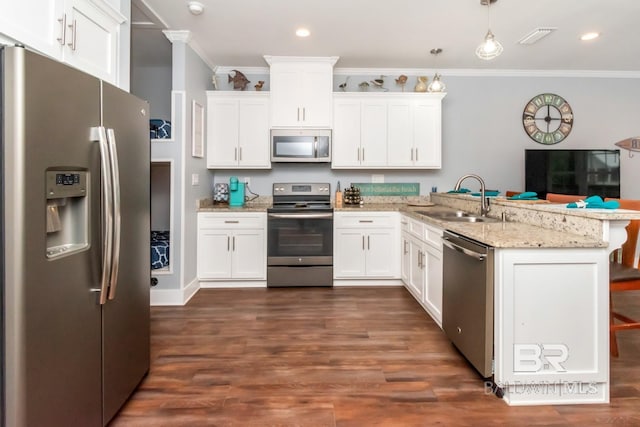 kitchen featuring white cabinetry, sink, decorative light fixtures, and appliances with stainless steel finishes