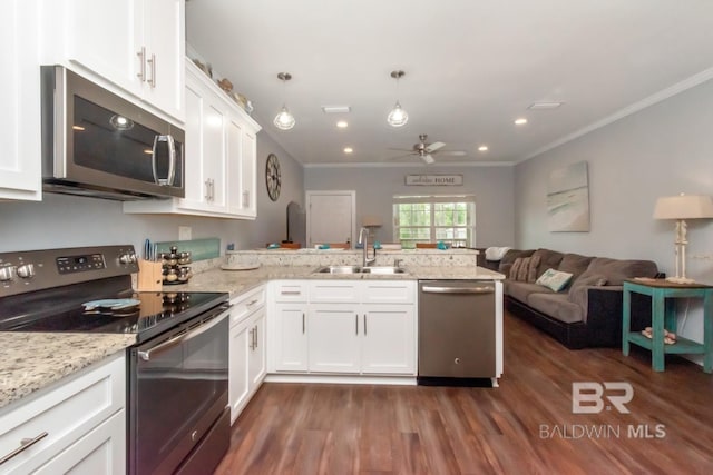 kitchen featuring appliances with stainless steel finishes, kitchen peninsula, sink, and white cabinets