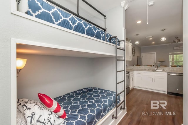 bedroom featuring dark wood-type flooring, ensuite bath, and sink