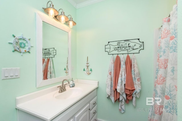 bathroom featuring ornamental molding and vanity