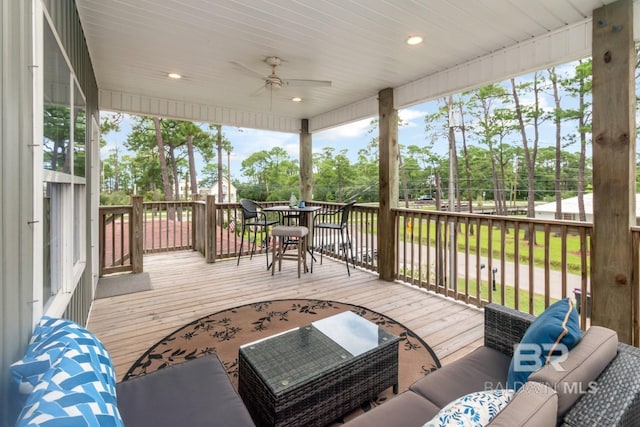 wooden deck featuring an outdoor hangout area and ceiling fan