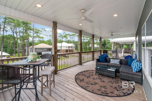 wooden terrace featuring a gazebo, outdoor lounge area, and ceiling fan