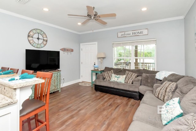 living room with crown molding, hardwood / wood-style floors, and ceiling fan