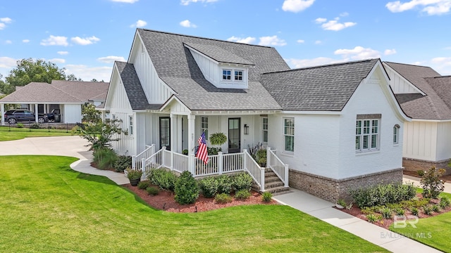 887 Geranium Dr, Fairhope, AL 36532 - modern farmhouse with covered porch, board and batten siding, brick siding, and a front lawn