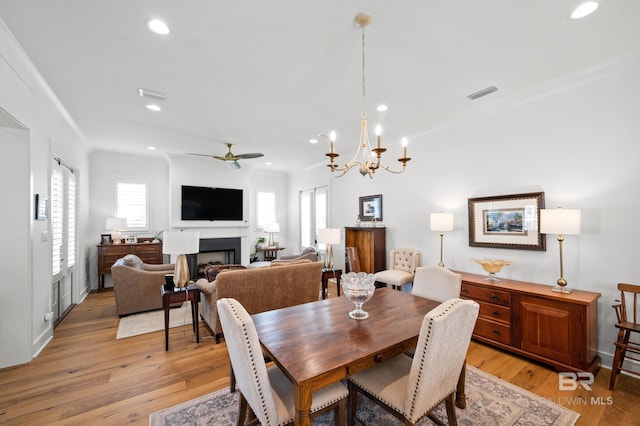 887 Geranium Dr, Fairhope, AL 36532 - dining space with a ceiling fan, light wood-type flooring, a fireplace, recessed lighting, and ornamental molding