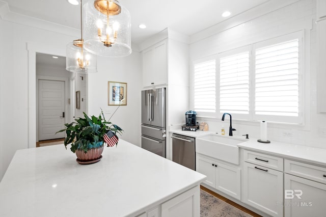 887 Geranium Dr, Fairhope, AL 36532 - kitchen with stainless steel appliances, a chandelier, a sink, light countertops, and white cabinets