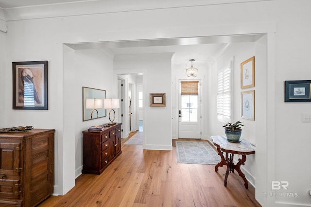 887 Geranium Dr, Fairhope, AL 36532 - foyer entrance with light wood-type flooring, a chandelier, and baseboards