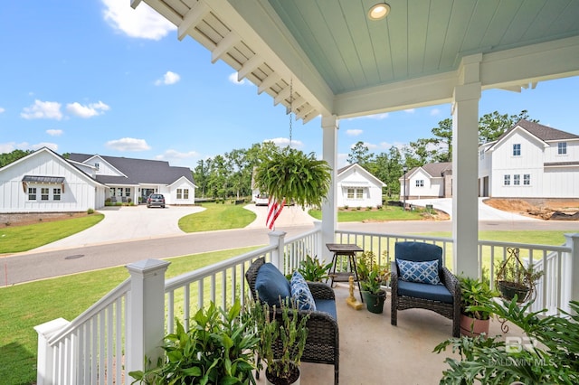 887 Geranium Dr, Fairhope, AL 36532 - covered porch with a residential view and a lawn