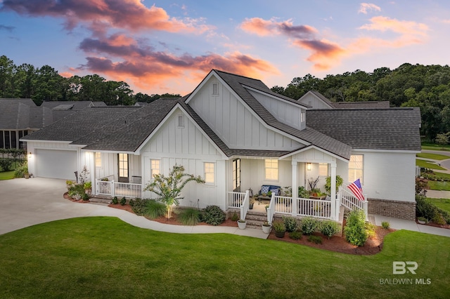 887 Geranium Dr, Fairhope, AL 36532 - modern farmhouse style home with a porch, board and batten siding, a shingled roof, and a front yard