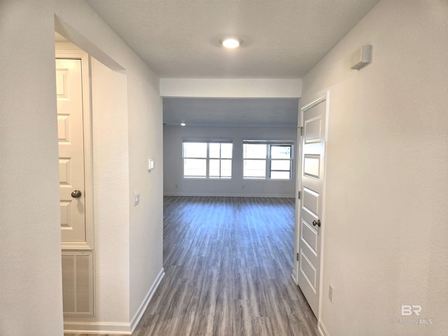 hall with dark hardwood / wood-style flooring