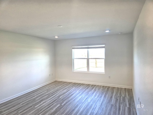 unfurnished room featuring dark wood-type flooring