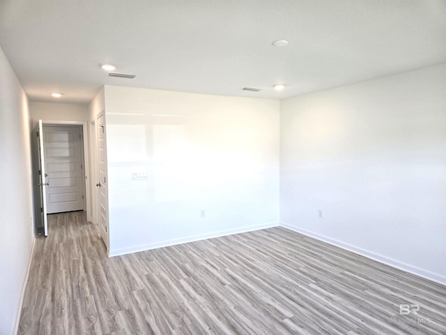 unfurnished room with light hardwood / wood-style floors