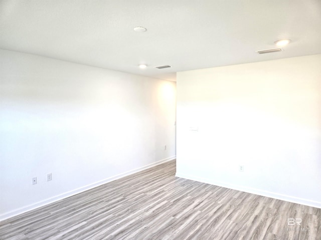 empty room with light hardwood / wood-style flooring