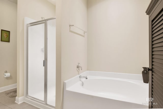 bathroom with tile patterned floors and independent shower and bath