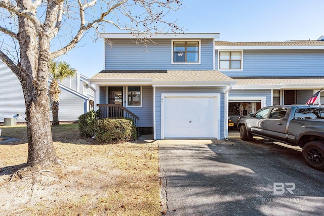 multi unit property with central AC, aphalt driveway, and roof with shingles