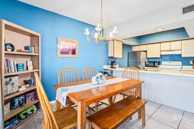 dining room with an inviting chandelier, light tile patterned floors, and visible vents