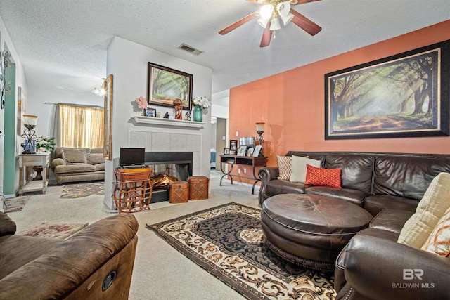 2511 Herman B Towner St, Eight Mile, AL 36613 - living room featuring carpet flooring, ceiling fan, a fireplace, and a textured ceiling