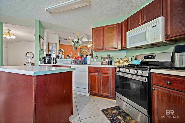 2511 Herman B Towner St, Eight Mile, AL 36613 - kitchen with white appliances, light tile patterned floors, light countertops, a textured ceiling, and a center island