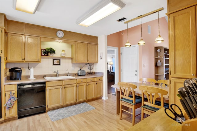 kitchen with light countertops, black dishwasher, decorative backsplash, light wood-style flooring, and a sink