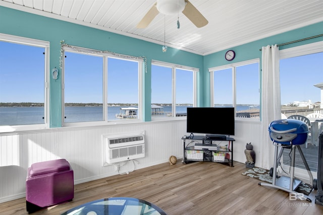 sunroom / solarium with an AC wall unit and ceiling fan