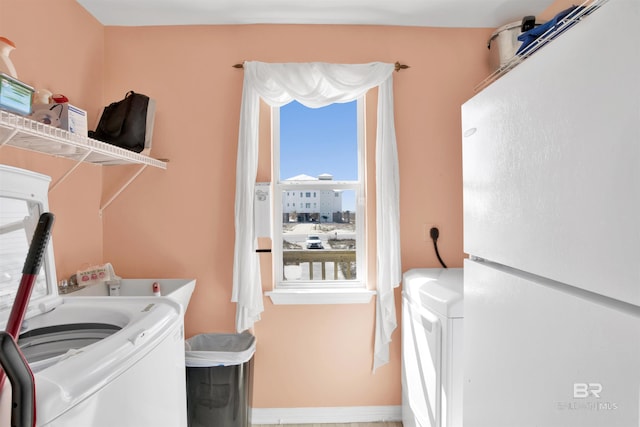 washroom featuring separate washer and dryer and laundry area