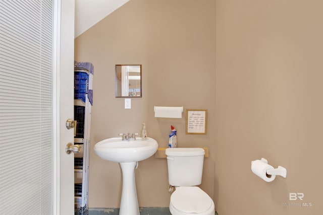 bathroom with vaulted ceiling and toilet