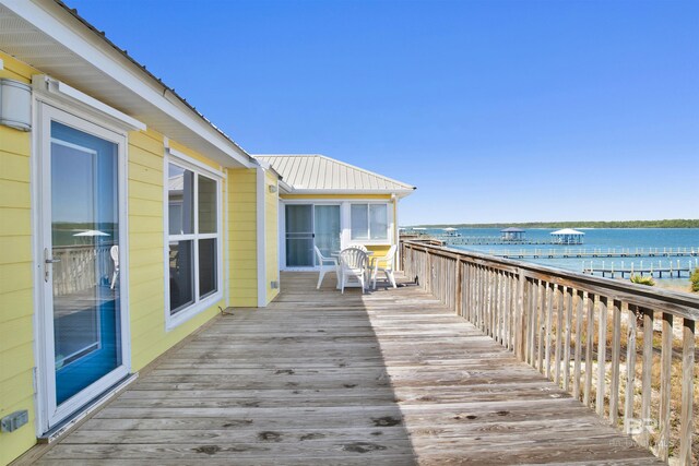 wooden deck featuring a water view