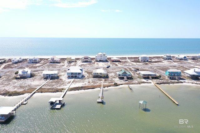 drone / aerial view with a water view and a beach view