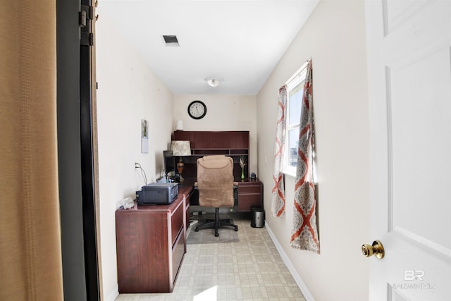 office area with visible vents, light floors, and baseboards