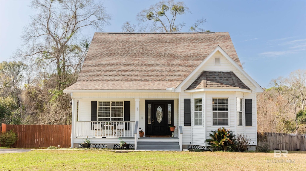 view of front of property with covered porch and a front lawn