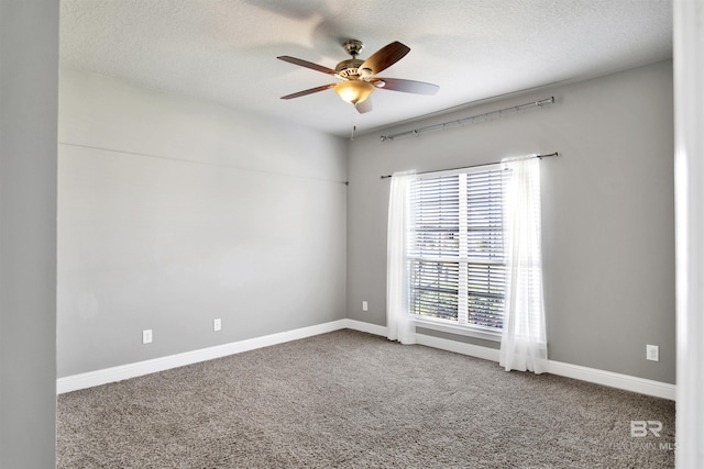 carpeted spare room with a ceiling fan, baseboards, and a textured ceiling