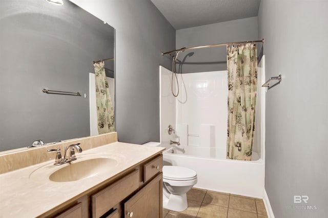 bathroom featuring tile patterned flooring, toilet, shower / tub combo with curtain, vanity, and a textured ceiling