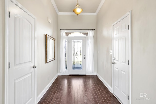 foyer with ornamental molding, baseboards, and dark wood-style flooring