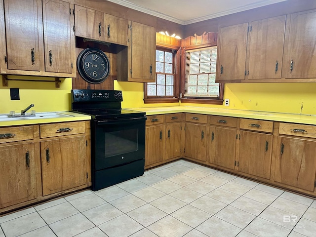 kitchen featuring brown cabinetry, black range with electric cooktop, light countertops, and crown molding